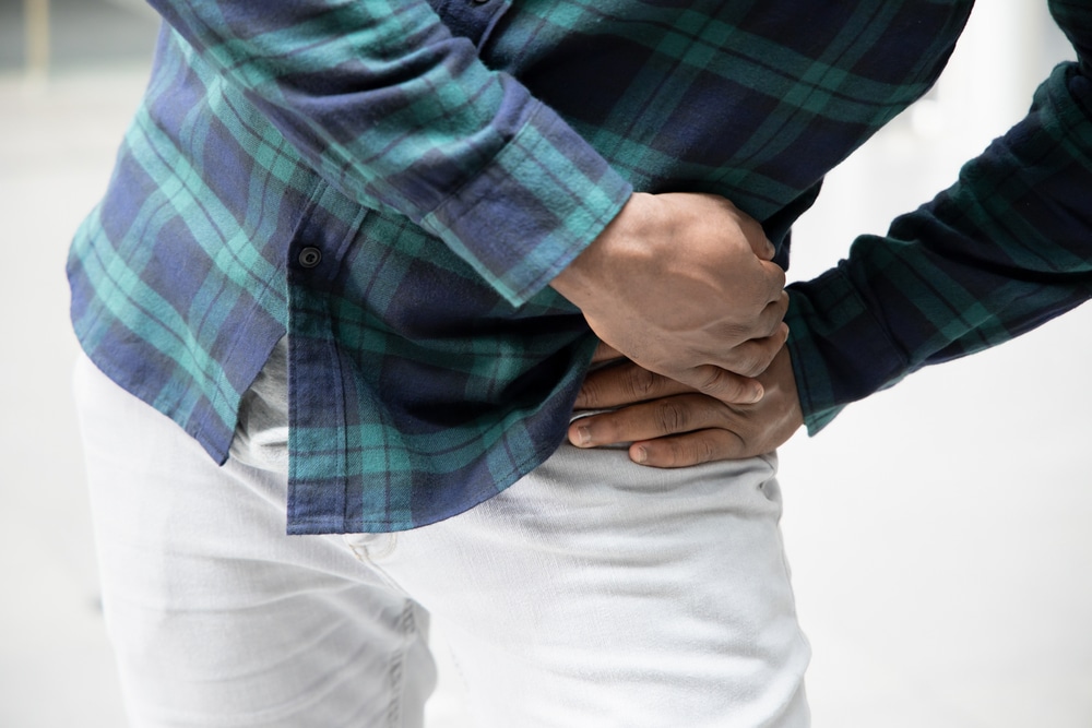 man holding his hip in pain from hip dysplasia